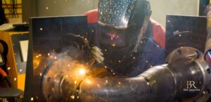 Industrial welder performing pipe welding